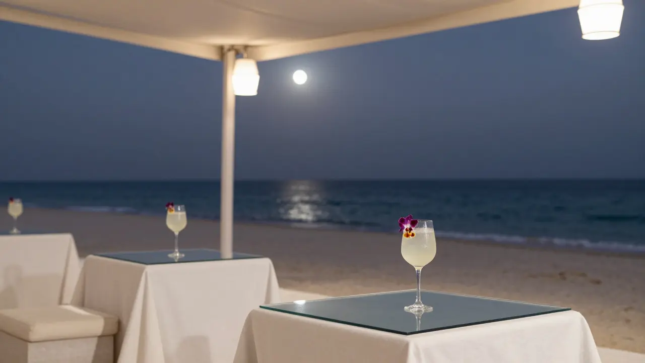 A couple sipping elegant cocktails under moonlight at Cielo Beach Dubai, serene and luxurious.